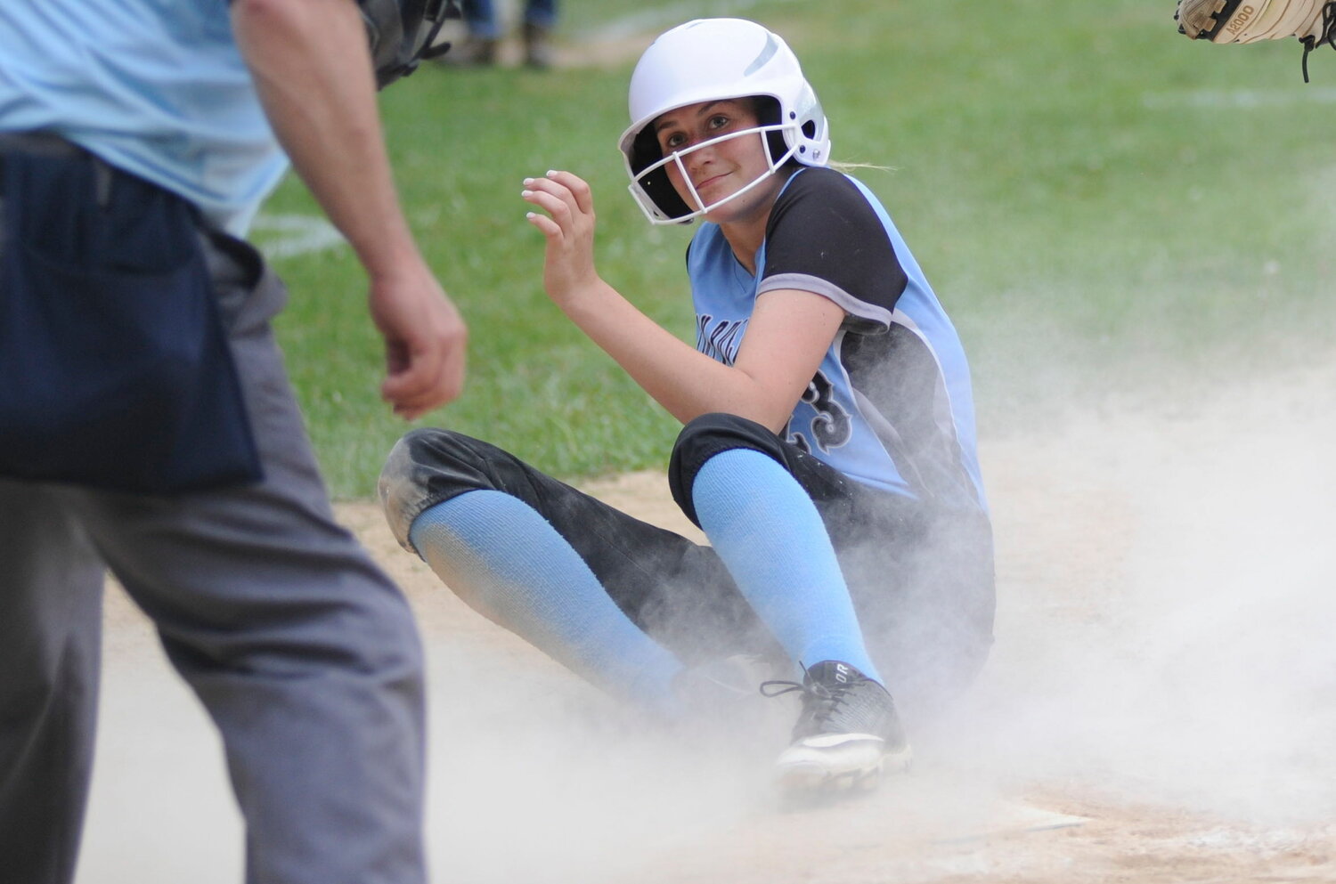 Anticipation! Sullivan West’s Elaine Herbert slides across the plate and looks to the home plate ump for “the call.”